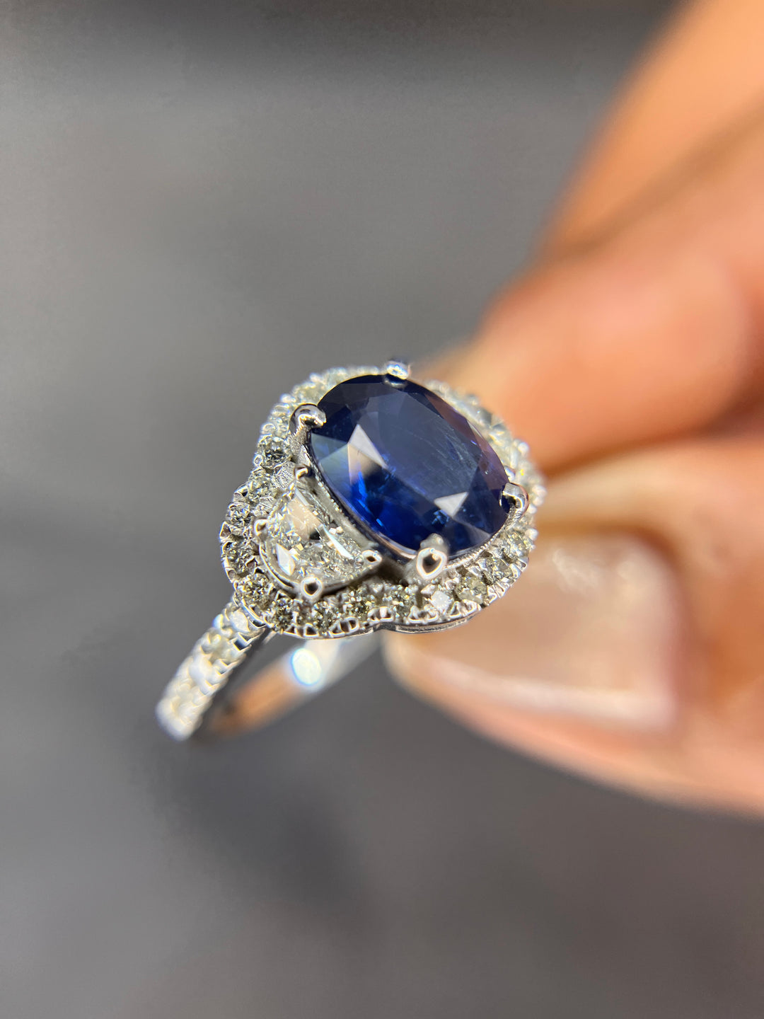 Halo Design 2 Ct. Tw. Oval Cut Natural Blue Sapphire with 1.25 Ct. Tw. Half Moon and Round Cut Side Diamond Ring